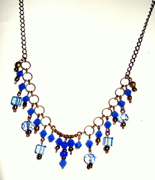 Necklace made of light and dark blue glass beads and gold small  beads on a chain of yellow metal - GLEZANT designer goods store. 