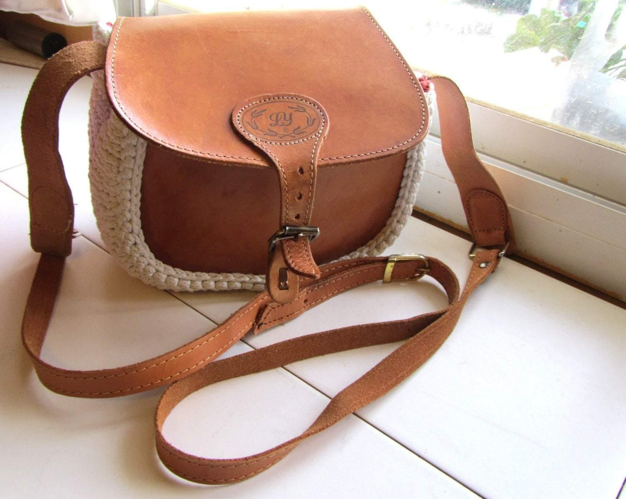 Crossbody / Shoulder bag made out of thick leather with a knitted fragment on a long leather strap - GLEZANT designer goods store.