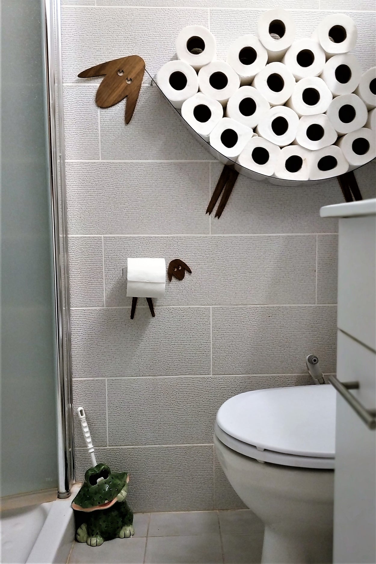 Shelf-Sheep for storing of toilet paper rolls with a roll holder-lamb