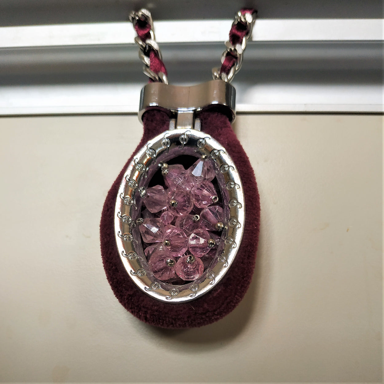 A massive shiny chain with a large wine-colored pendant