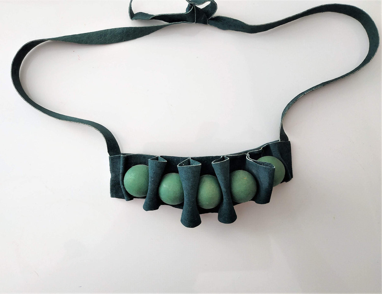 Modern necklace made of green suede and green wooden balls - GLEZANT designer goods store. 